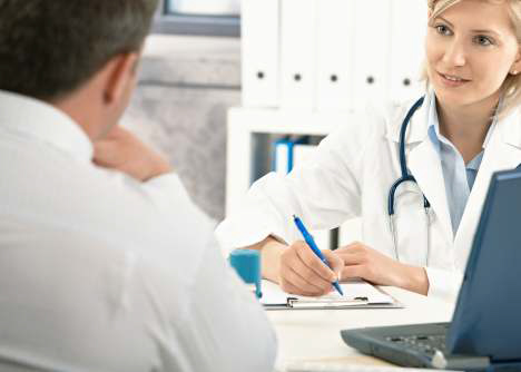a hidradenitis suppurativa specialist is talking to a patient at a desk.