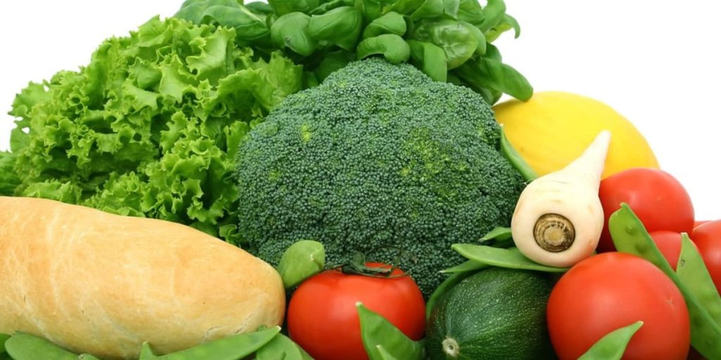 a variety of vegetables are arranged on a white background, promoting a healthy diet.