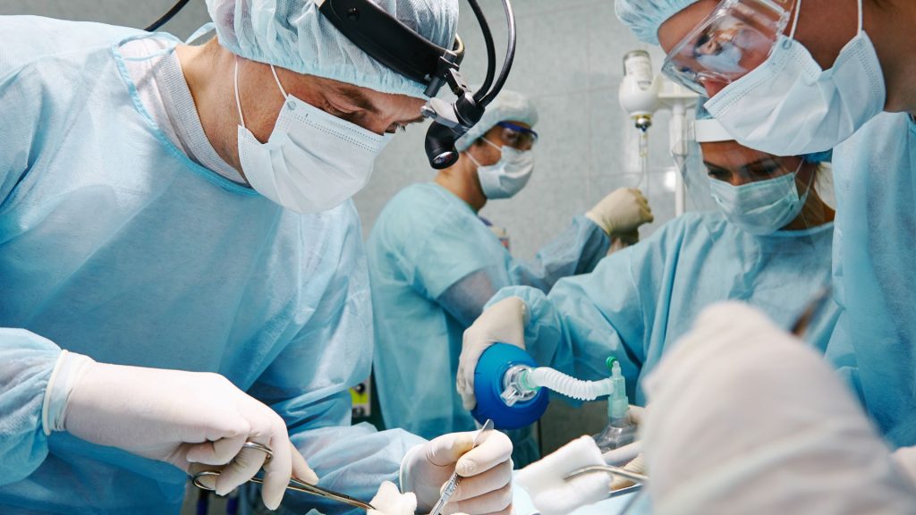 a group of surgeons working in an operating room for emerging treatments for hidradenitis suppurativa