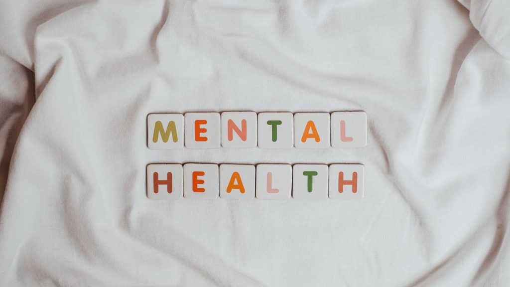 How Hidradenitis Suppurativa Affects On Psychological Health the word mental health spelled out on a white shirt, highlighting the impact of hidradenitis suppurativa on psychological well-being.