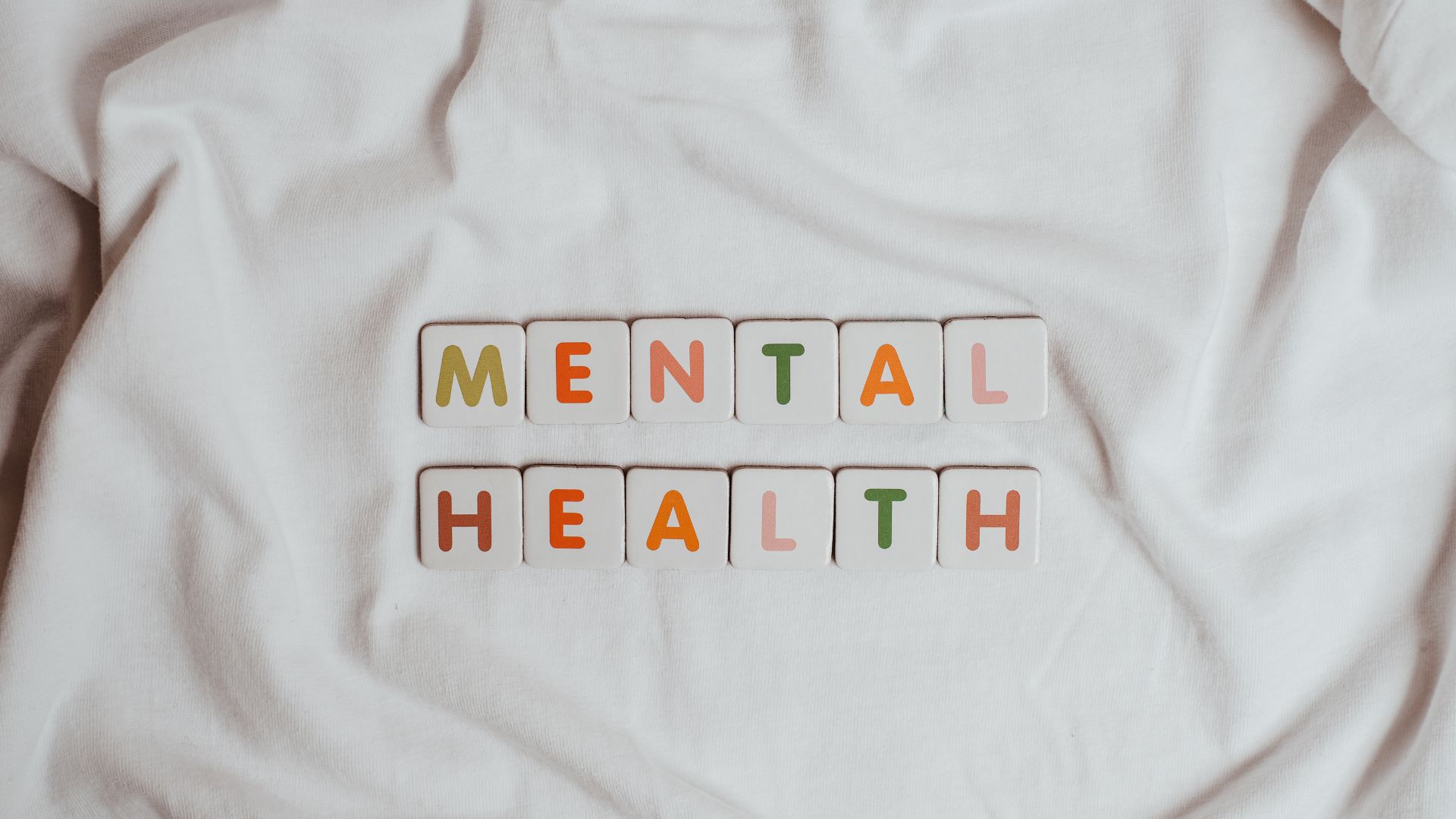 The word mental health spelled out on a white shirt, highlighting the impact of Hidradenitis Suppurativa on psychological well-being.
